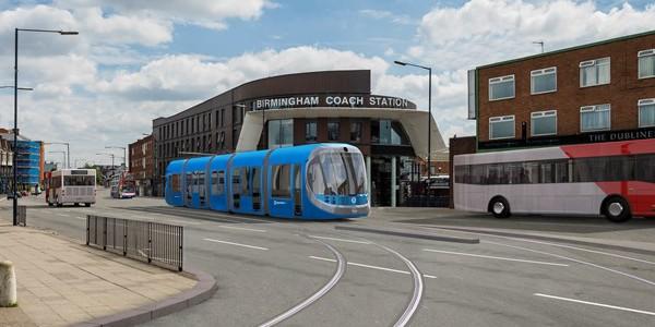 Blue tram near Birmingham Coach Station on a city street